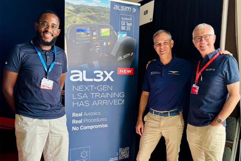 Three men stand beside a tall banner advertising al3x next gen LSA training at an aviation event