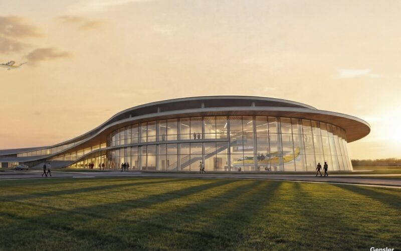 Electra Ohio Manufacturing Facility Concept Modern glass walled pavilion with a curved roof at sunset people walking on adjacent paths and a grassy foreground