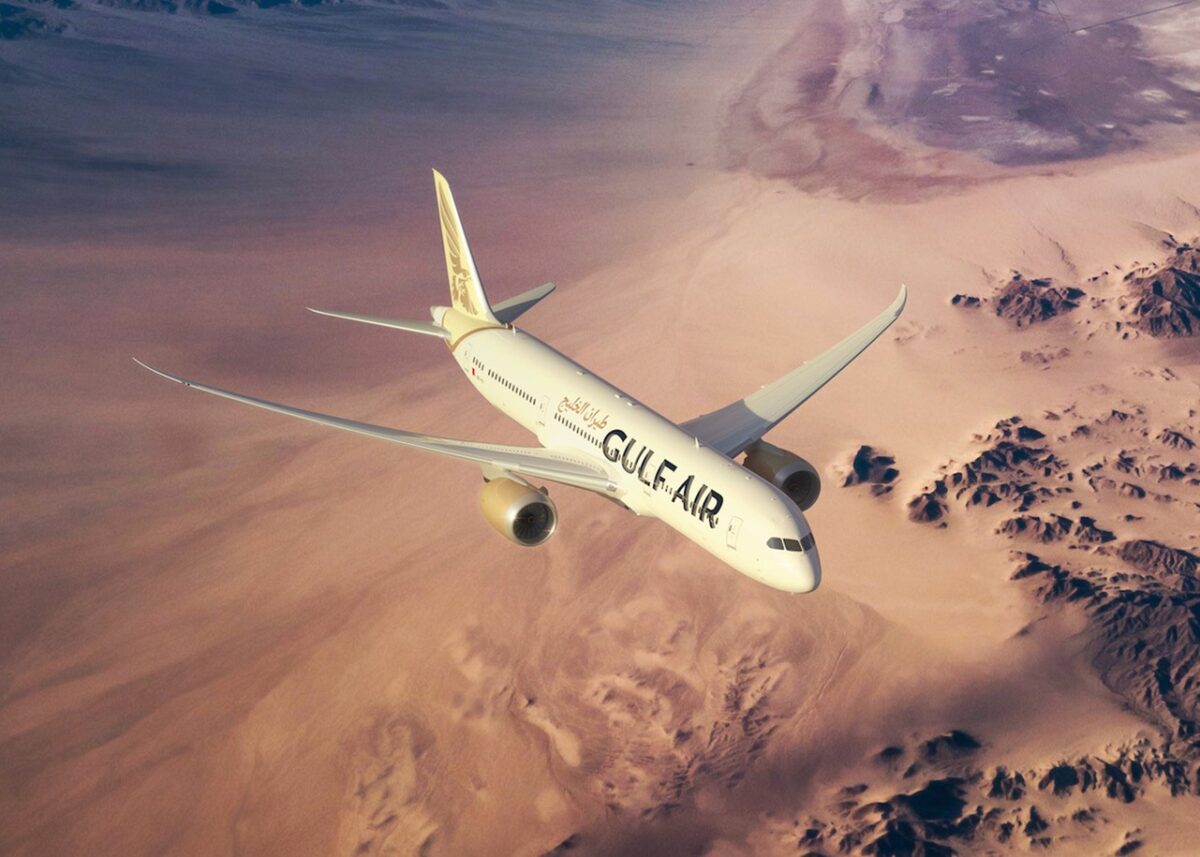 Gulf Air Boeing 787 9 Dreamliner Gulf Air jet soaring above a desert with brown sand and rocky outcrops seen from above