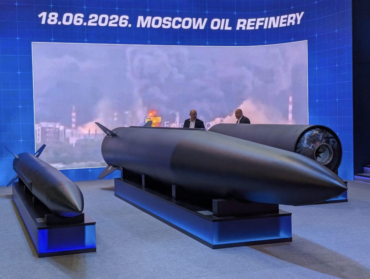 Models of Fire Points FP 7 tactical ballistic missile and larger FP 9 ballistic missile displayed at Eurosatory 2026 in Paris Exhibition display a large dark missile on a stand with two suited figures discussing it blue backdrop reading 18062026 MOSCOW OIL REFINERY