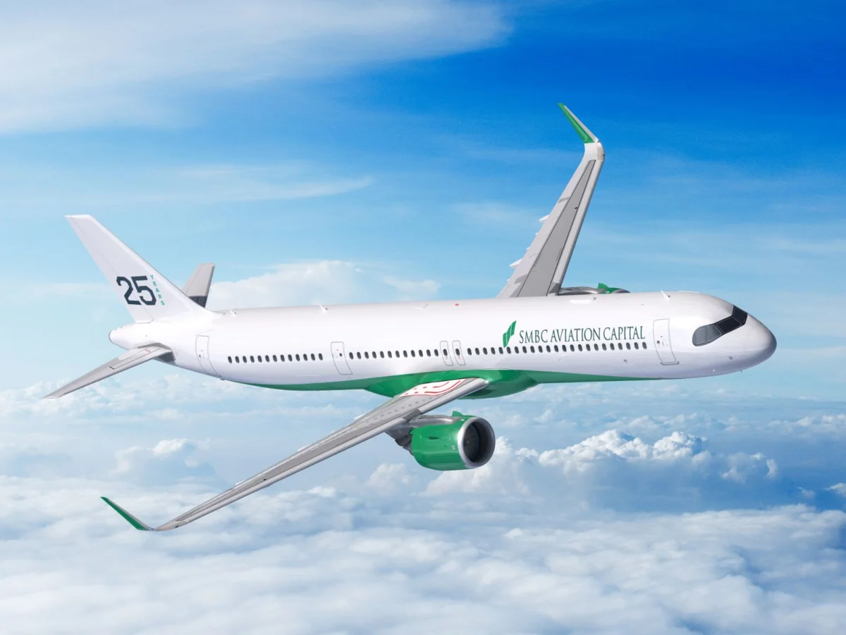 SMBC Aviation Capital White commercial airplane with green accents and SMBC Aviation Capital logo in flight above clouds