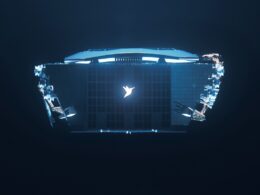 Top down view of a laptop floating in dark space glowing blue with a white bird logo at the center of the keyboard