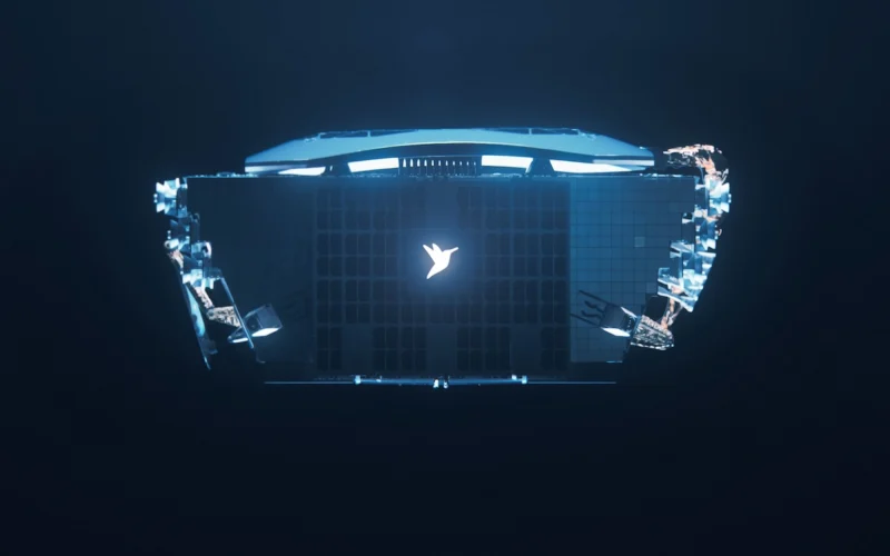 Top down view of a laptop floating in dark space glowing blue with a white bird logo at the center of the keyboard