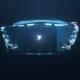 Top down view of a laptop floating in dark space glowing blue with a white bird logo at the center of the keyboard