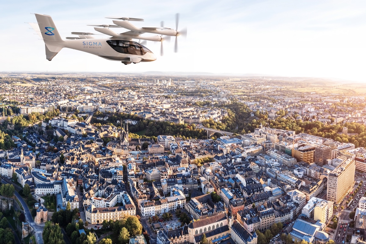 Sigma Luxembourg Sigma Air Mobility eVTOL aircraft flying over a dense cityscape at sunset with rotors spinning above rooftops