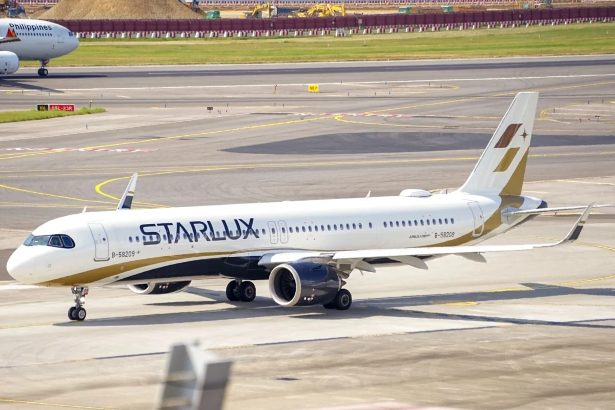 StarLux jet on the taxiway at the airport with a Philippines Airlines plane visible in the background