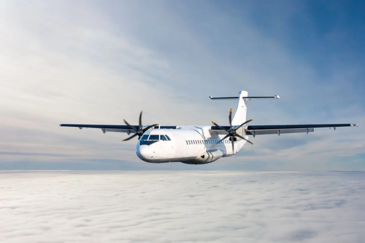 Asia Pacific turboprop operators gather for AAPA safety talk White twin engine propeller airplane flying above a sea of clouds against a blue sky viewed from the front