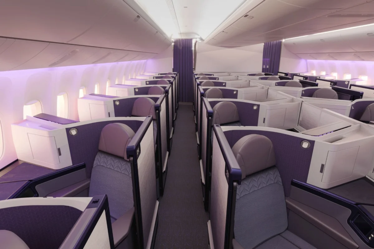 Air New Zealand shares first look at new 777 cabin design Premium airline cabin with individual lie flat pods in a 2 2 2 layout and purple accents