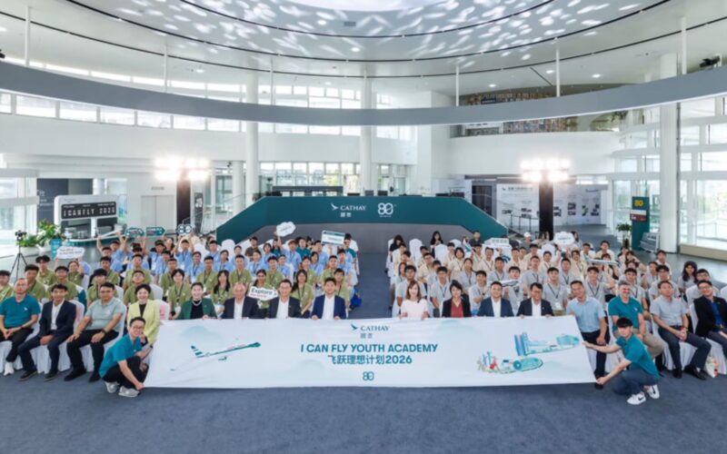 Cathays I Can Fly unites Hong Kong mainland China students Large crowd of people in a bright atrium pose for a group photo behind a banner that reads I CAN FLY YOUTH ACADEMY with Cathay logos in the background