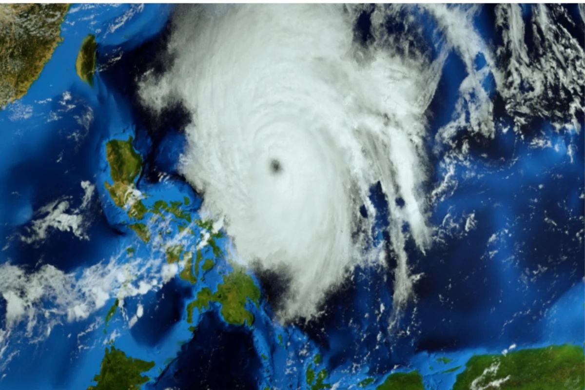 Satellite image of a massive tropical cyclone with a distinct eye over the ocean near Australia clouds spiraling outward