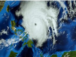 Satellite image of a massive tropical cyclone with a distinct eye over the ocean near Australia clouds spiraling outward