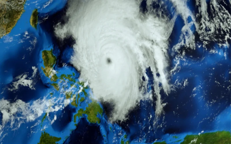 Satellite image of a massive tropical cyclone with a distinct eye over the ocean near Australia clouds spiraling outward