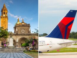 Historic church with a clock tower and domed roof in a plaza on the left a Delta airplane tail on the right with blue red and white colors in flight prep on the runway