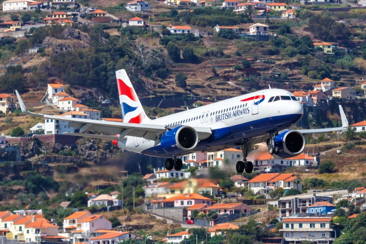British Airways picks GTF engines for up to 63 Airbus jets British Airways airplane in landing attitude over hillside town with orange roofed houses and greenery behind