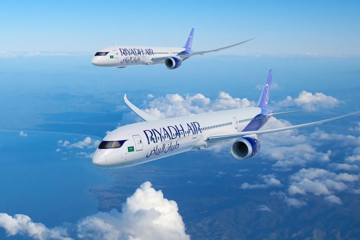 Riyadh Air firms up order for 28 Boeing 787 Dreamliners Two Ryanair airplanes in flight over a sea of white clouds against a bright blue sky one closer to the viewer and another farther away in formation