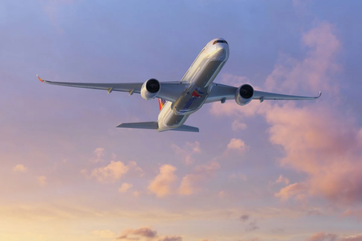 Philippine Airlines orders Rolls Royce A350 1000 engines Commercial airliner photographed from below as it soars through a pastel sunset sky engines visible under the wings with a colorful tail