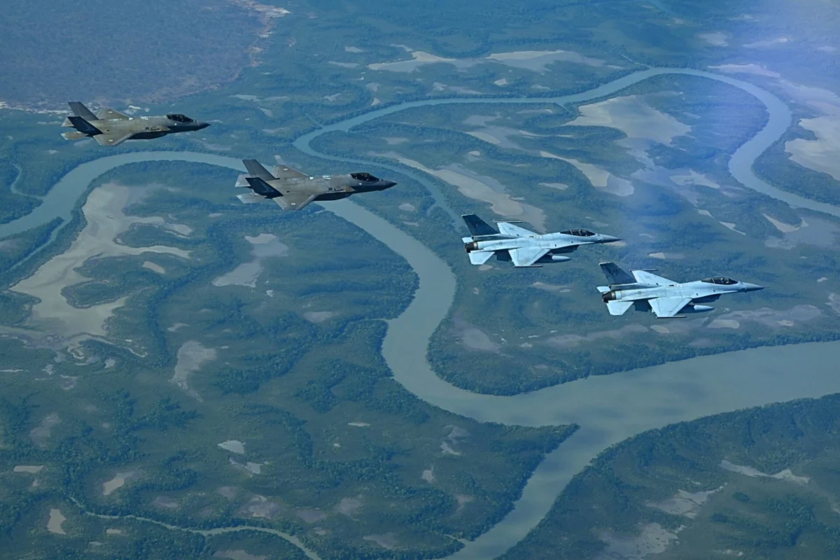 RAAF F 35As South Korean KF 16s mark 75 year friendship Four stealth fighter jets fly in formation above a winding braided river and green forested valley