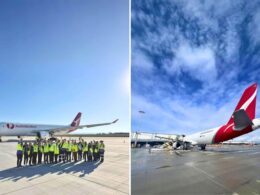 Group of airport ground crew in hi vis vests posing on the tarmac beside an Australia Post cargo jet