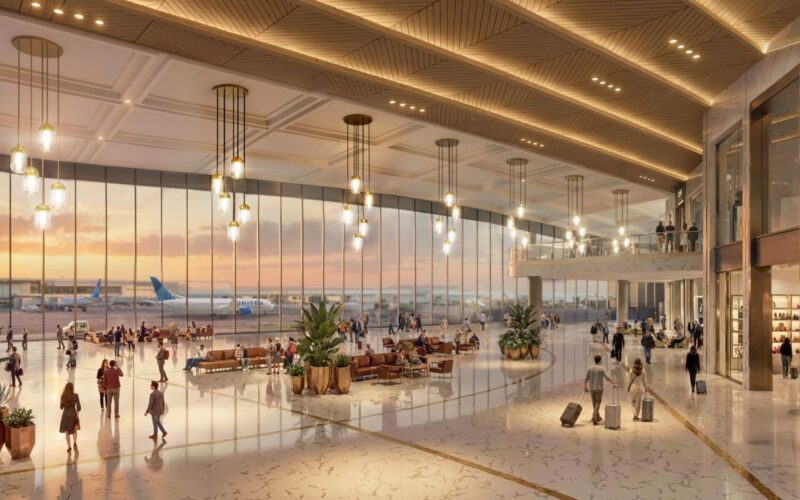 United and Dulles unveil billion airport overhaul Bright spacious airport terminal with large glass walls warm hanging lights and passengers walking to gates