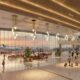Bright spacious airport terminal with large glass walls warm hanging lights and passengers walking to gates