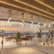 Bright spacious airport terminal with large glass walls warm hanging lights and passengers walking to gates