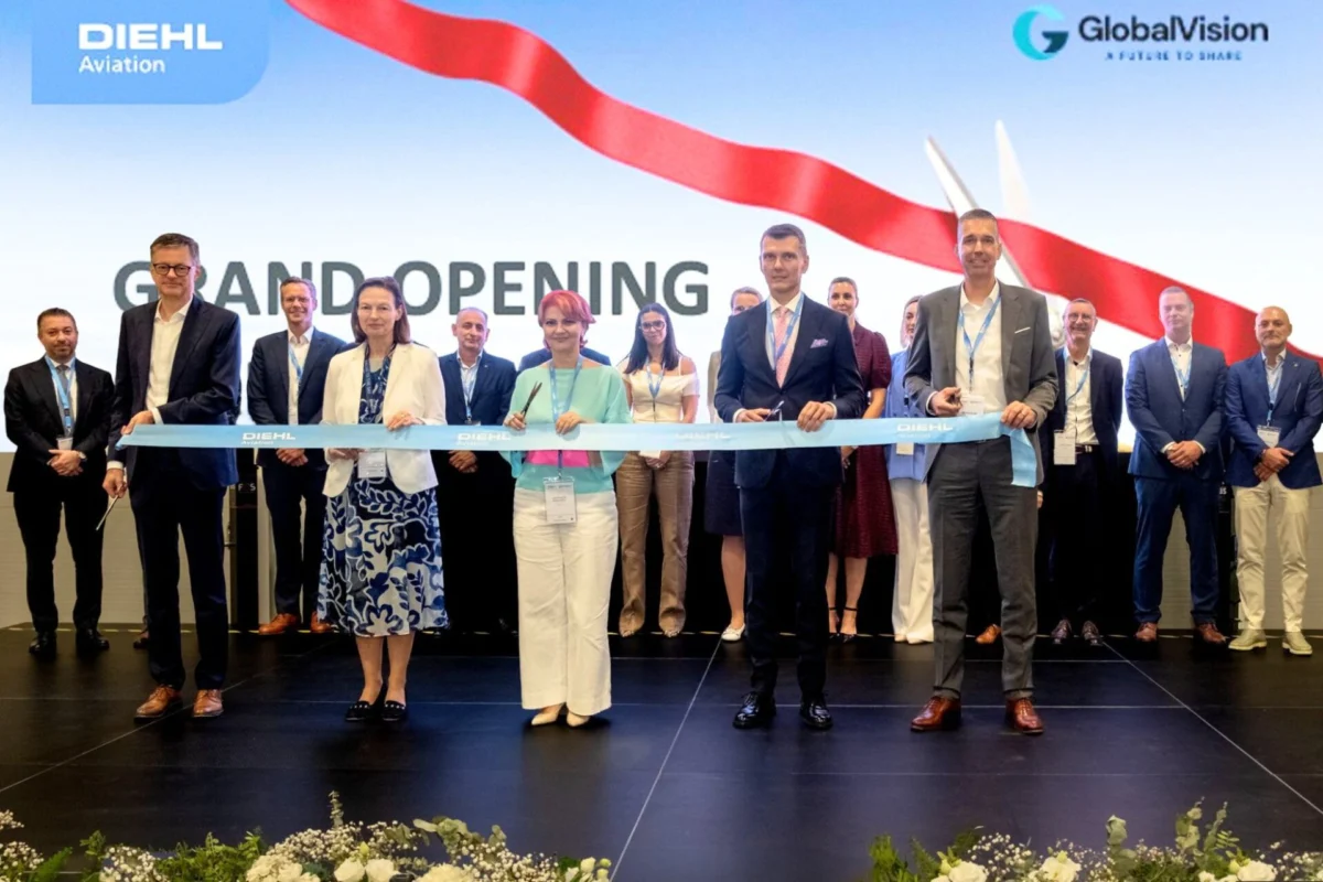 Diehl Aviation opens new facility in Craiova Romania Group of professionals cutting a blue ribbon at a grand opening on a stage with DIEHL Aviation and GlobalVision logos in the background