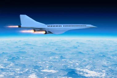 White jet airliner flying above a sea of clouds against a deep blue sky engines blazing