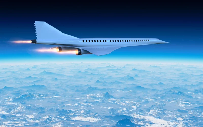 White jet airliner flying above a sea of clouds against a deep blue sky engines blazing