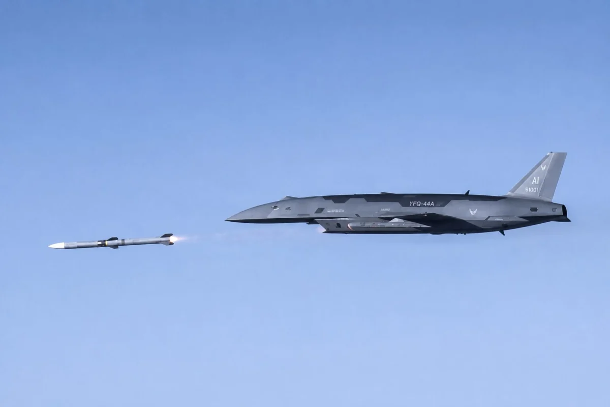 andmis Gray stealth bomber in flight releasing a missile with a visible exhaust flame against a clear blue sky
