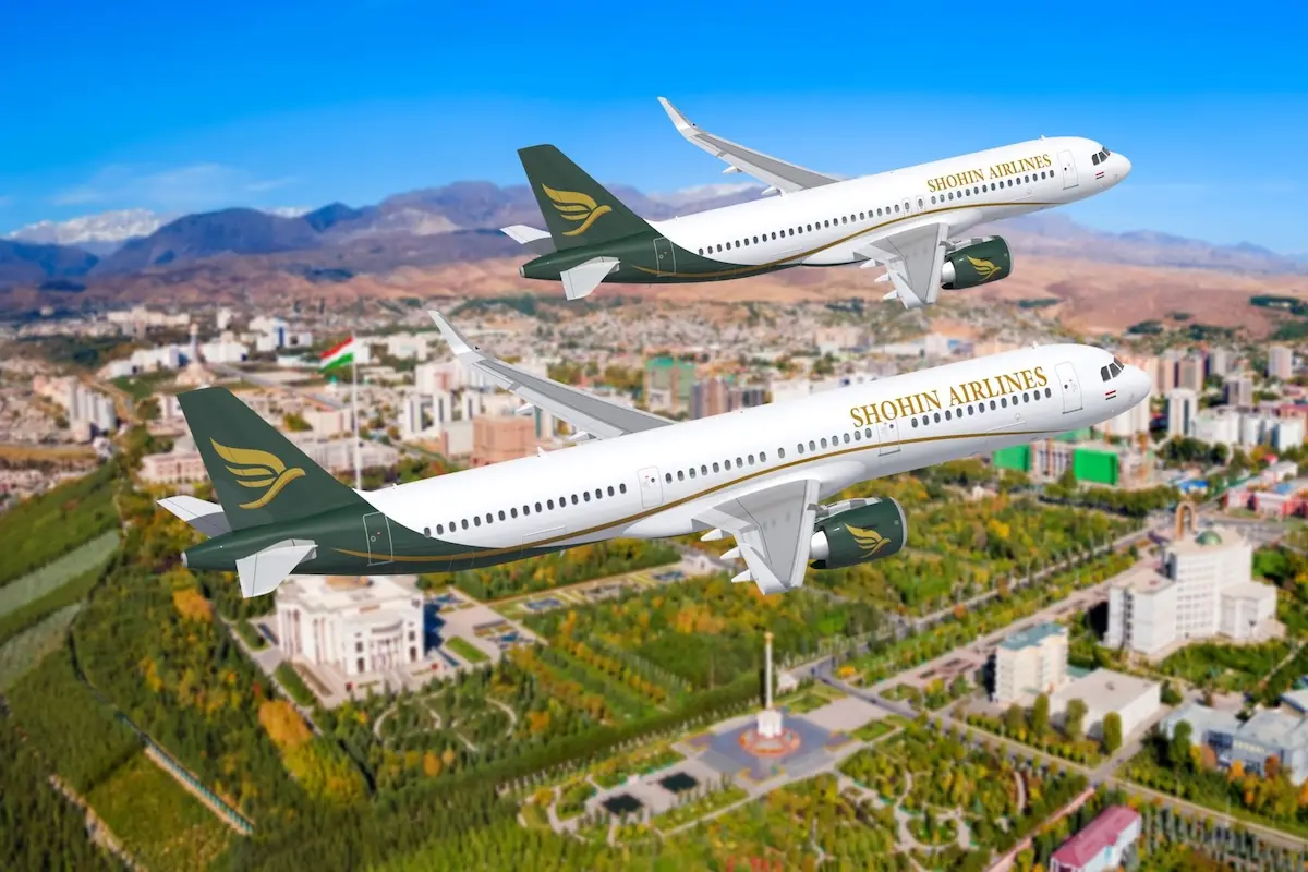 shohin airlines airbus Two Shohin Airlines planes fly in formation over a city with green parks and mountains in the background blue sky overhead