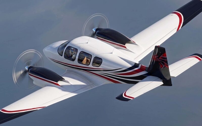 sling twin rendering 1 Private twin engine propeller aircraft in level flight with white red and black livery visible cockpit windows and rotating propellers creating motion blur