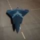 Top down view of a dark blue stealth jet on a runway seen from above