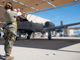 A US Air Force airman marshals an A 10C Thunderbolt II ahead of the Warthogs final flight from Davis Monthan Air Force Base on July 29 2026