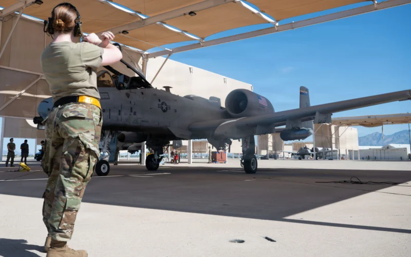 A US Air Force airman marshals an A 10C Thunderbolt II ahead of the Warthogs final flight from Davis Monthan Air Force Base on July 29 2026