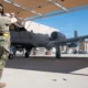 A US Air Force airman marshals an A 10C Thunderbolt II ahead of the Warthogs final flight from Davis Monthan Air Force Base on July 29 2026