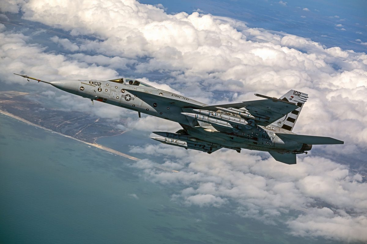 AIM 424 Long Range Air to Air Missiles LRAAM US Navy fighter jet in flight above cloudy sky with missiles mounted under the wings