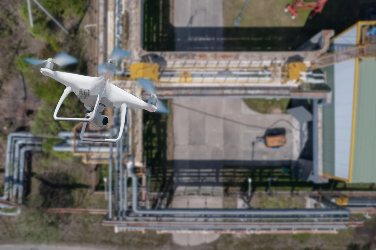 A quadcopter flies over an industrial facility A quadcopter flies over an industrial facility