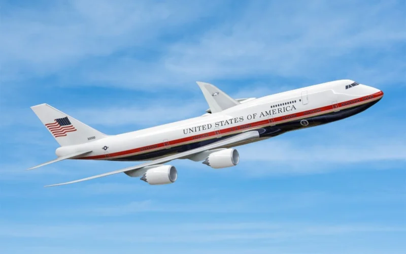 Airplane labeled United States of America mid flight against a blue sky