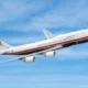 Airplane labeled United States of America mid flight against a blue sky