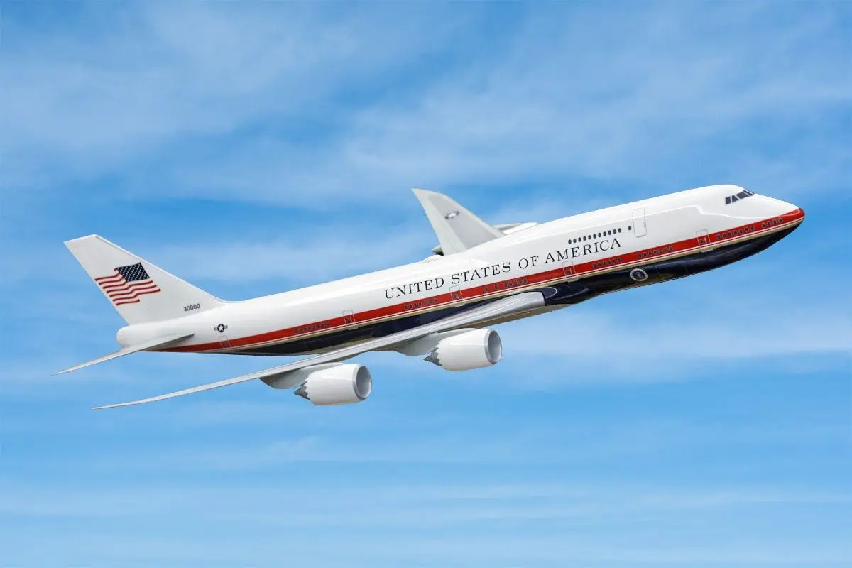 Airplane labeled United States of America mid flight against a blue sky