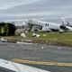 Air Canada Express jet with severe damage and surrounding debris on a runway overturned ground equipment nearby at a damaged airport scene