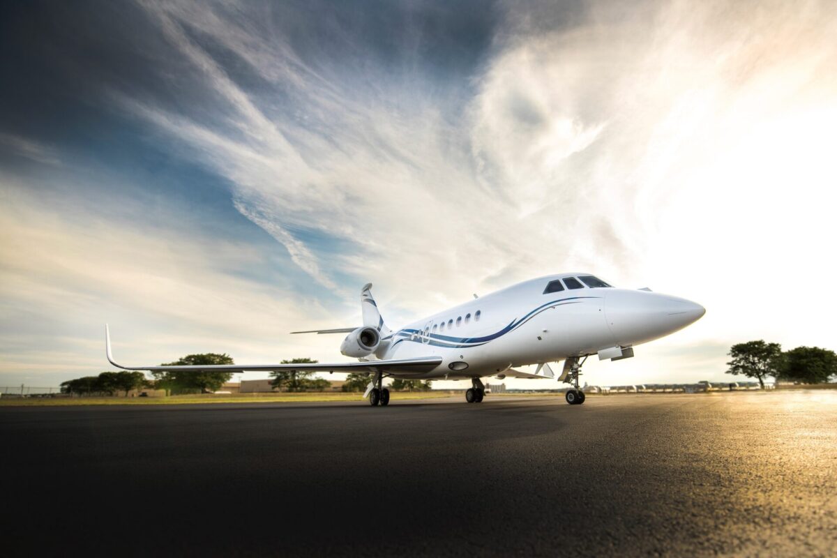 ResizedFinalEdited Front right view of a white corporate jet parked on a runway blue sky and dramatic clouds above