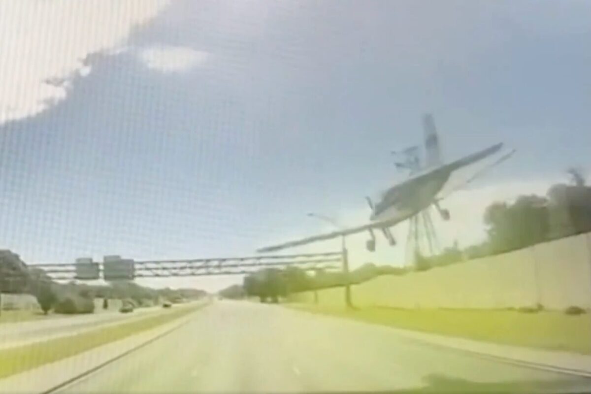 Screenshot Partially collapsed elevated roadway leaning to the side with twisted metal and debris along a sunlit highway