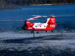 The NSW Rural Fire Services CH 47D Chinook HeliTak 211 N47CU uses its snorkel to refill its 11300 liter internal water tank