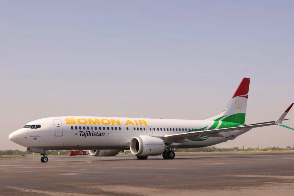 Somon Air jet on the runway with Tajikistan branding and a red green tail fin