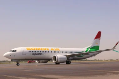 Somon Air jet on the runway with Tajikistan branding and a red green tail fin