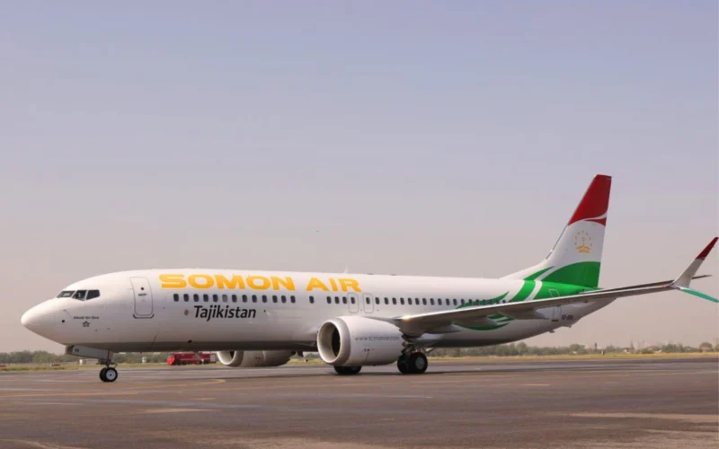 Somon Air jet on the runway with Tajikistan branding and a red green tail fin