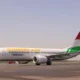 Somon Air jet on the runway with Tajikistan branding and a red green tail fin