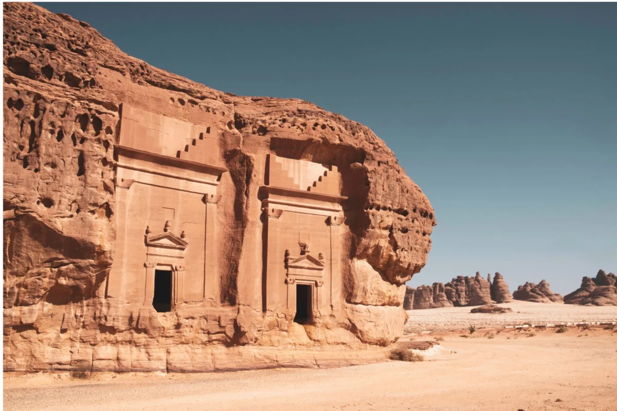 Delta launches first nonstop US Saudi Arabia route Ancient sandstone temple carved into a red cliff featuring arched doorways and decorative pediments in a desert landscape
