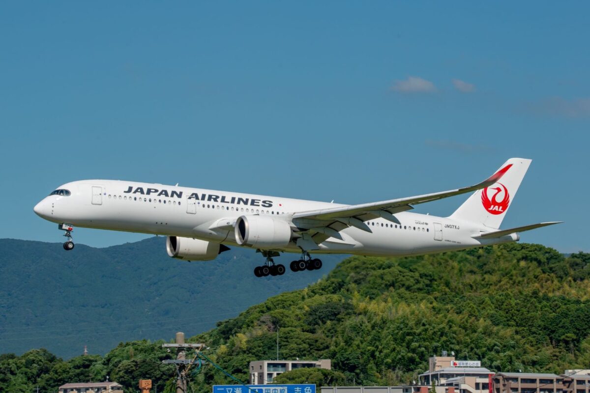 JAL codeshare deal to boost Fukuoka as gateway to Japan Japan Airlines passenger jet with landing gear down flying low above green hills against a blue sky